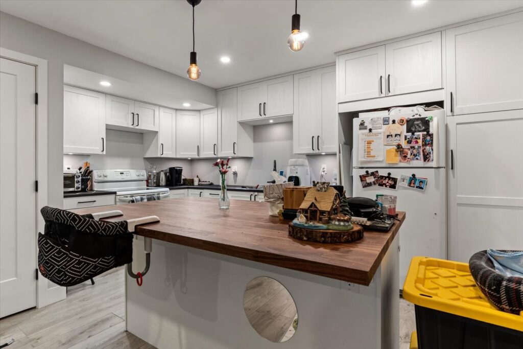 Kitchen with butcher block island and pendant lights at 915 34909 Old Yale Road
