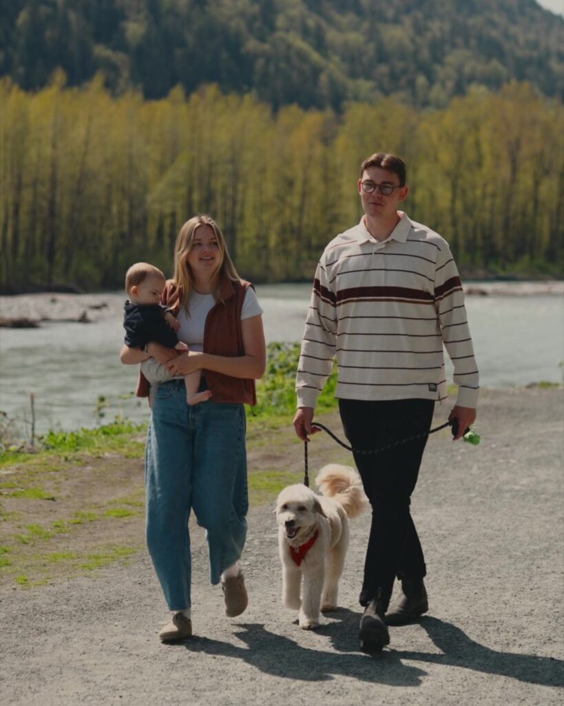 Nahum and Carly Hoeppner walking with their baby and Dune by the Vedder River