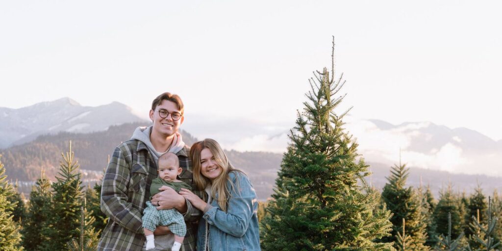 The Hoeppner family among the trees with the Chilliwack mountains behind