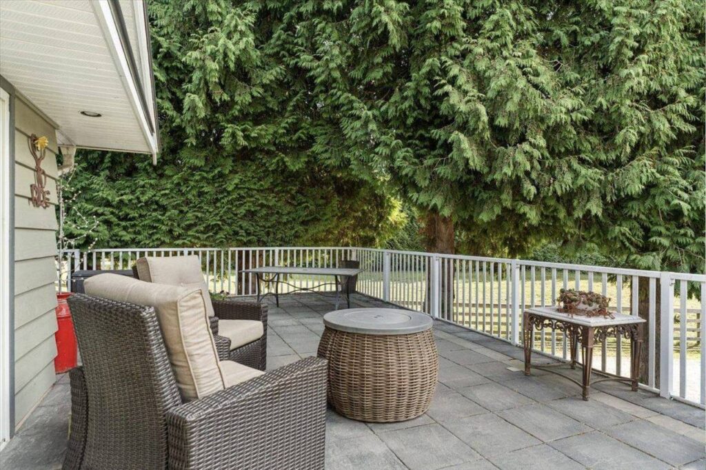 Large deck with patio seating overlooking the yard at 42420 Adams Road
