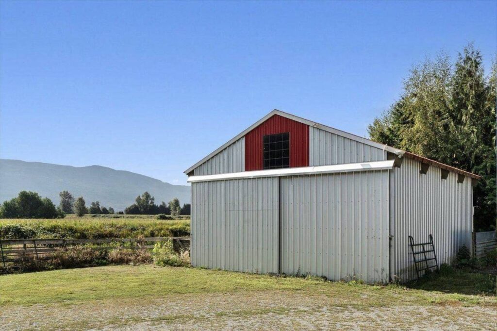 Detached steel workshop beside open farmland at 42420 Adams Road