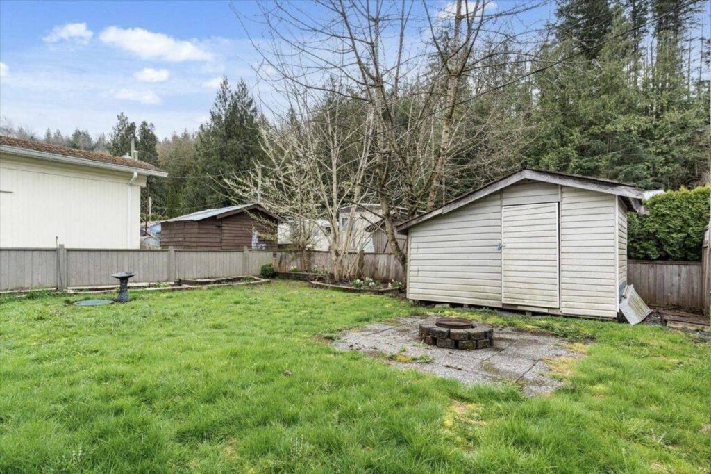 Backyard with fire pit and storage shed at 28 3942 Columbia Valley Road