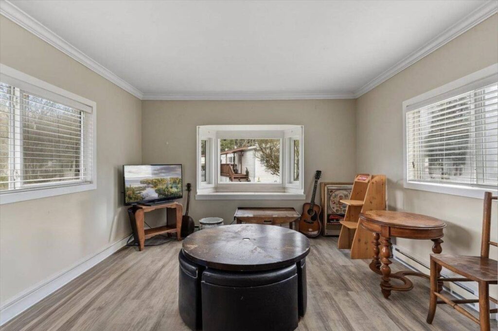 Living room with a bay window at 28 3942 Columbia Valley Road