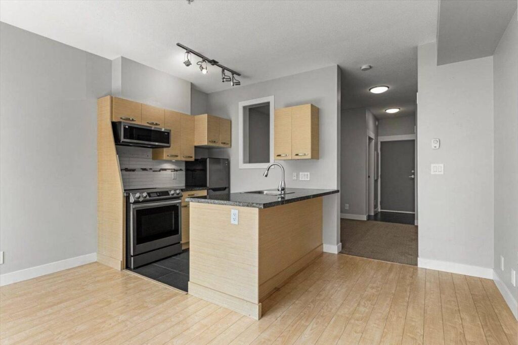 Kitchen with granite counters and stainless appliances at 310 33539 Holland Avenue