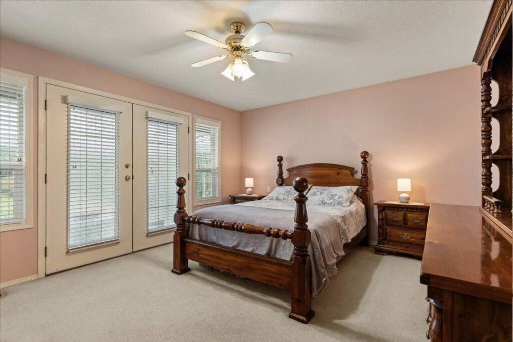 Primary bedroom with French doors to the back lawn at 42703 Janzen Road