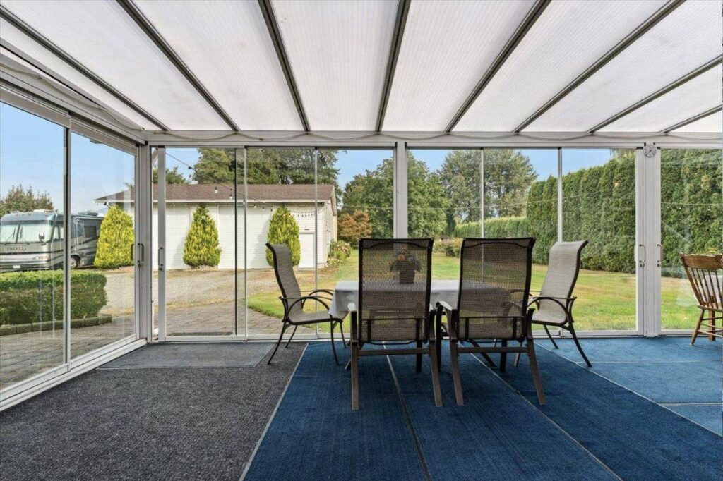 Lumon sunroom looking out to the shop and lawn at 42703 Janzen Road