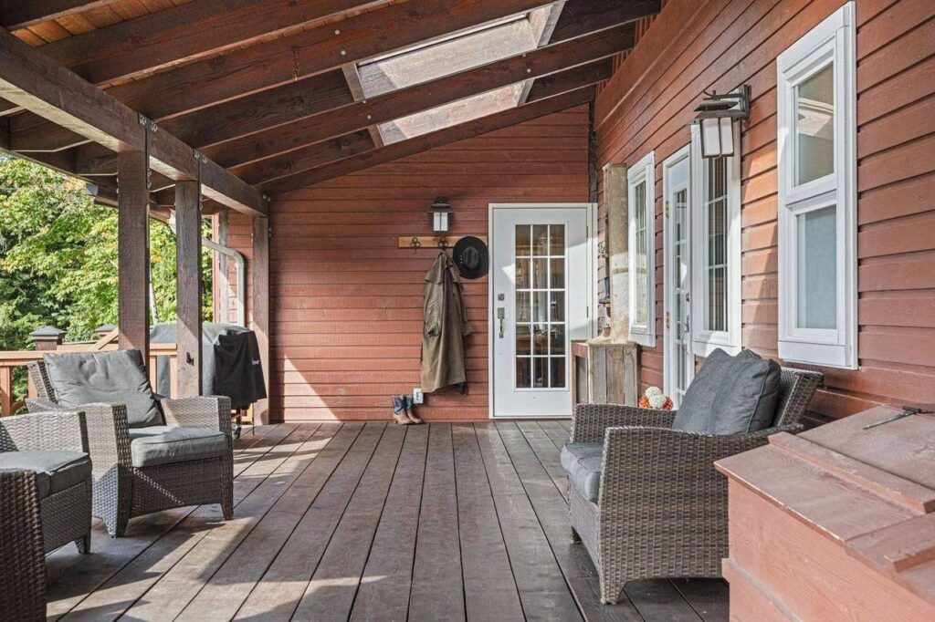 Covered deck along the front of the house at 48625 Wincott Road