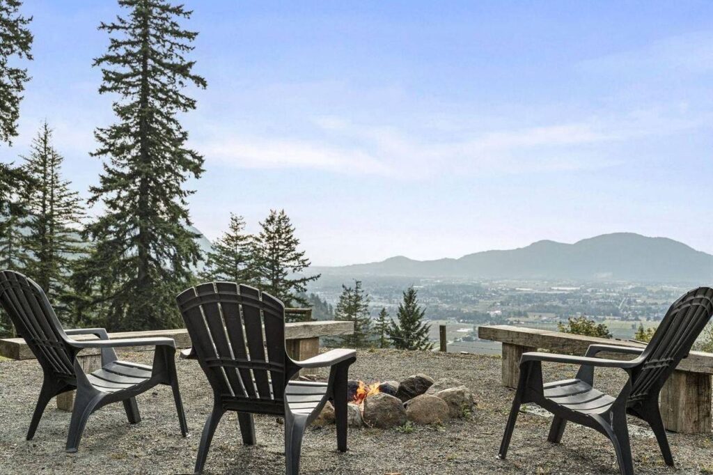 Fire pit with Adirondack chairs and a valley view at 48625 Wincott Road