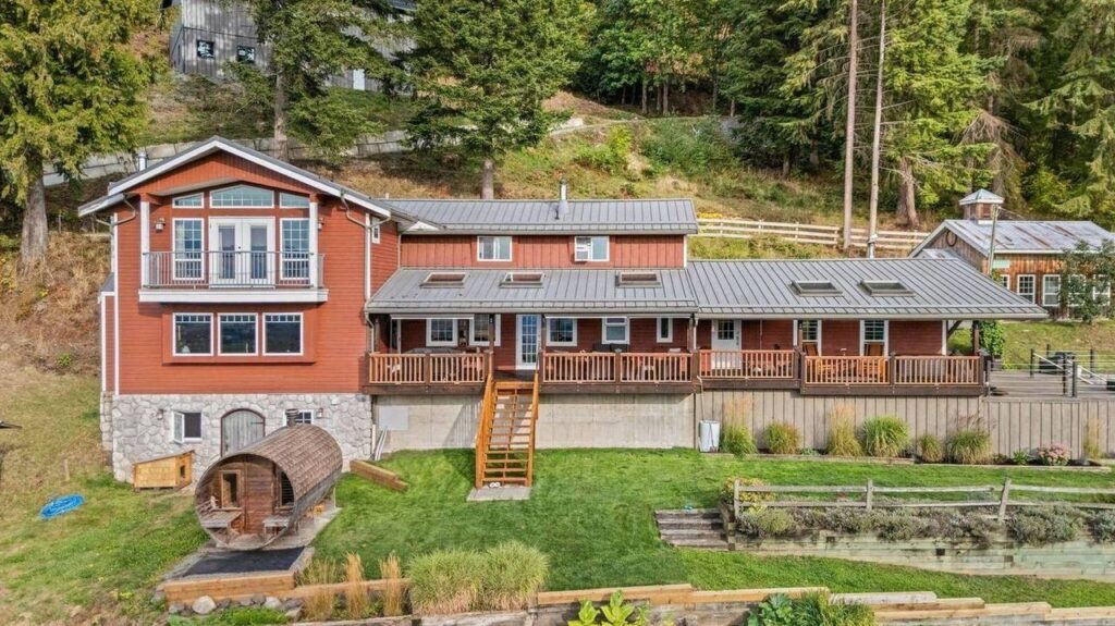 Aerial view of the main house, decks and barrel sauna at 48625 Wincott Road in Ryder Lake