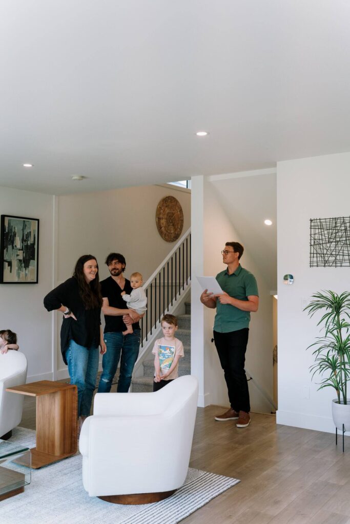 Nahum Hoeppner leading a family through a Chilliwack home