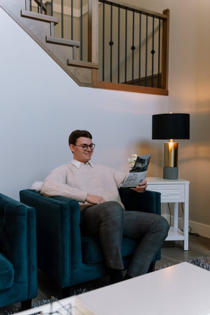 Nahum Hoeppner reading a listing feature sheet in a staged living room